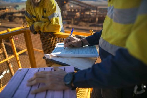 midsection-colleagues-construction-site